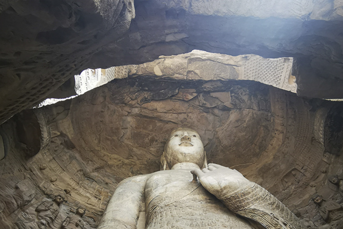 The Yungang Grottoes statue of Buddha in Datong, North China’s Shanxi province. Photo: Li Xin/Caixin